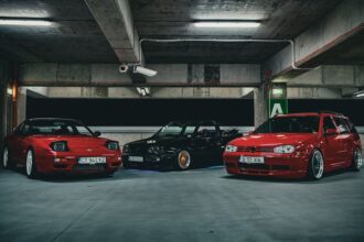 sh tuning - A group of three stylish sports cars parked under ambient lighting in an urban garage se