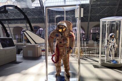 universum bremen - Historic space suits showcased in a museum with ample natural light.